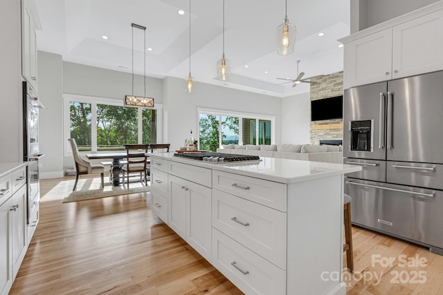 128 Saddle Ridge Dr, Alexander, NC 28701 - kitchen featuring stainless steel appliances, a raised ceiling, light countertops, a ceiling fan, and recessed lighting