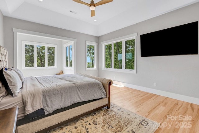 128 Saddle Ridge Dr, Alexander, NC 28701 - bedroom with multiple windows, wood finished floors, a raised ceiling, ceiling fan, and recessed lighting
