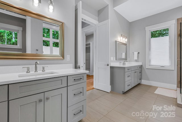 128 Saddle Ridge Dr, Alexander, NC 28701 - full bathroom featuring two vanities, tile patterned floors, and an enclosed shower
