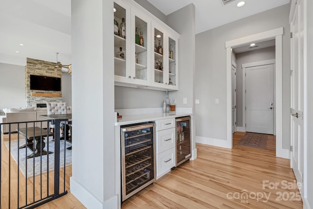 128 Saddle Ridge Dr, Alexander, NC 28701 - indoor dry bar featuring wine cooler, light wood finished floors, recessed lighting, and a fireplace