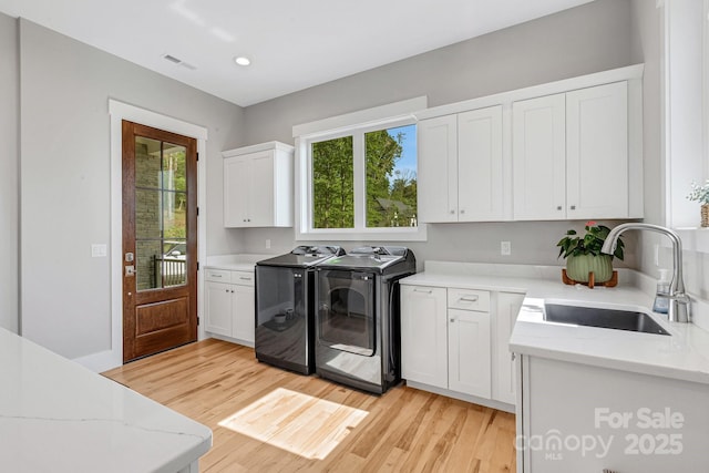 128 Saddle Ridge Dr, Alexander, NC 28701 - kitchen featuring independent washer and dryer, light wood-style flooring, white cabinetry, light stone counters, and recessed lighting