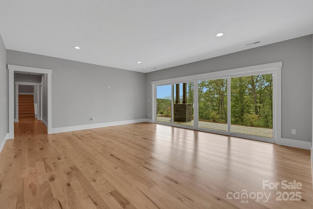 128 Saddle Ridge Dr, Alexander, NC 28701 - unfurnished room with light wood-type flooring, stairway, and recessed lighting