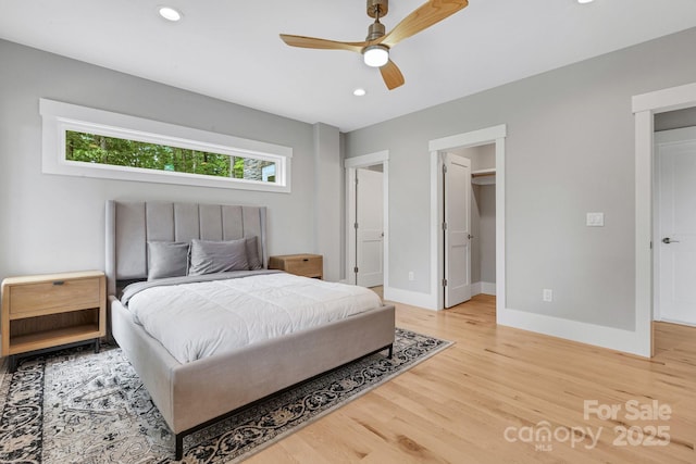 128 Saddle Ridge Dr, Alexander, NC 28701 - bedroom featuring light wood-type flooring, a spacious closet, recessed lighting, and a ceiling fan