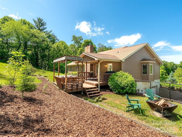 575 Upper Glady Fork Rd, Candler, NC 28715 - rear view of house with a fire pit, a chimney, a deck, and a shingled roof