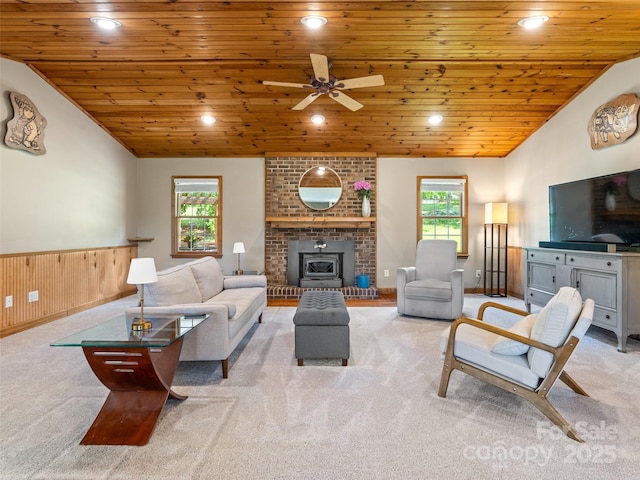 575 Upper Glady Fork Rd, Candler, NC 28715 - carpeted living room featuring vaulted ceiling, wood ceiling, a wainscoted wall, ceiling fan, and a fireplace