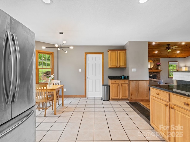 575 Upper Glady Fork Rd, Candler, NC 28715 - kitchen with freestanding refrigerator, a brick fireplace, dark countertops, a chandelier, and recessed lighting