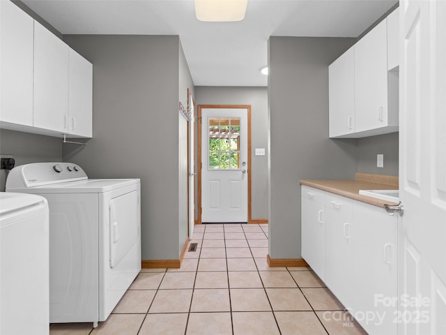 575 Upper Glady Fork Rd, Candler, NC 28715 - washroom featuring cabinet space, washing machine and dryer, baseboards, and light tile patterned floors