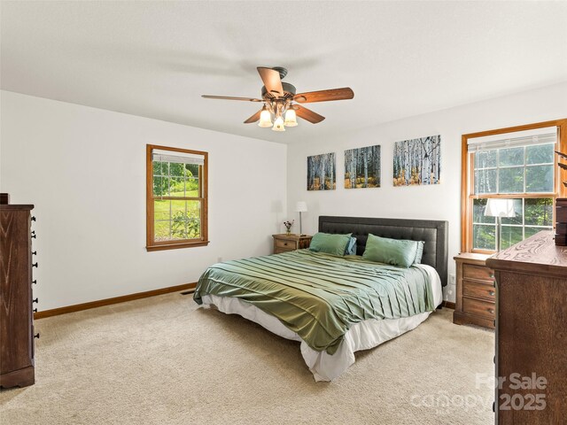575 Upper Glady Fork Rd, Candler, NC 28715 - bedroom featuring multiple windows, light colored carpet, baseboards, and ceiling fan