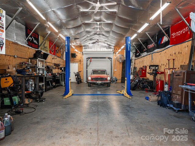 575 Upper Glady Fork Rd, Candler, NC 28715 - garage featuring a workshop area and wood walls