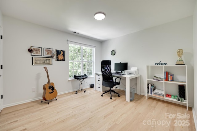 office area with wood finished floors and baseboards