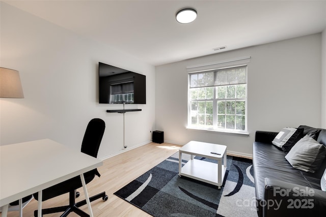 office space with wood finished floors and baseboards