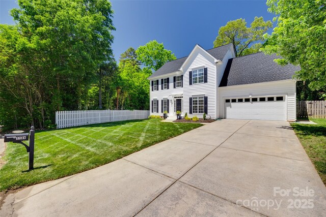 1134 Blueberry Ln, Charlotte, NC 28226 - colonial inspired home featuring an attached garage, concrete driveway, and roof with shingles