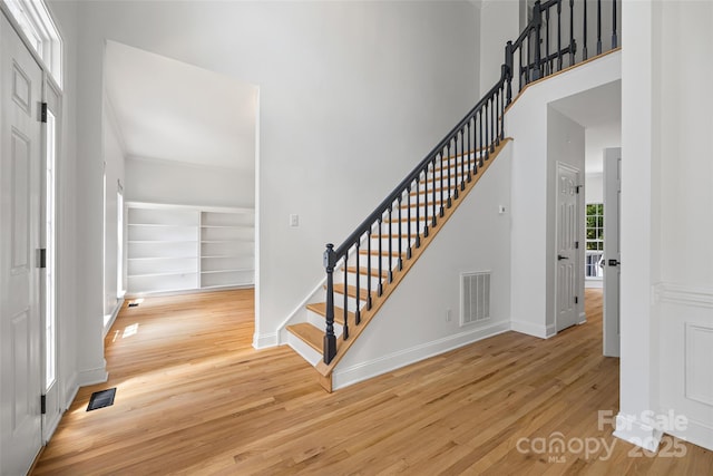 1134 Blueberry Ln, Charlotte, NC 28226 - entryway featuring wood finished floors, stairs, and a towering ceiling