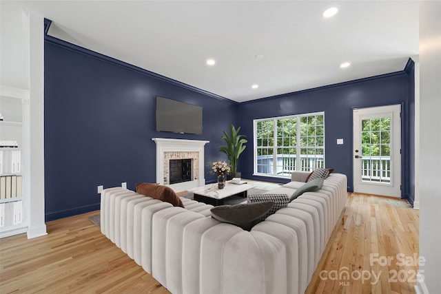 1134 Blueberry Ln, Charlotte, NC 28226 - living room with light wood-style floors, ornamental molding, a fireplace, and recessed lighting