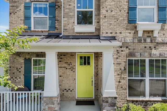 5366 Meadowcroft Way, Fort Mill, SC 29708 - doorway to property featuring a standing seam roof, brick siding, covered porch, and metal roof