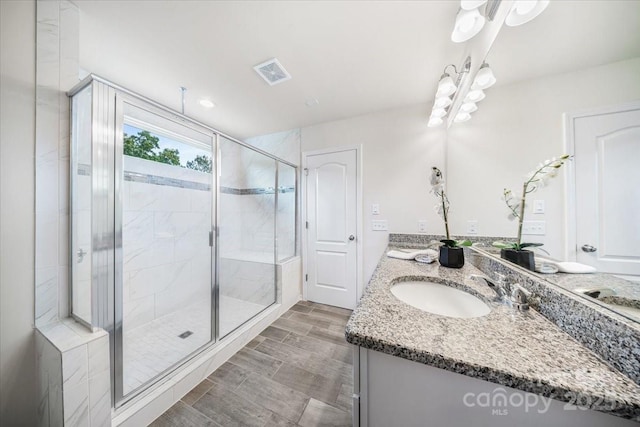 5366 Meadowcroft Way, Fort Mill, SC 29708 - bathroom featuring a stall shower, vanity, a chandelier, and wood tiled floors