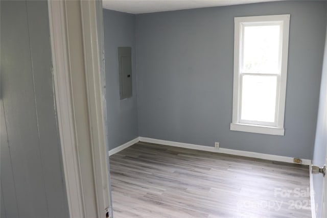 614 Goldsboro Ave, Statesville, NC 28677 - spare room with electric panel, plenty of natural light, light wood-style flooring, and baseboards