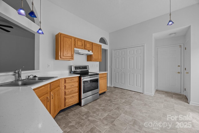 1321 Land Grant Rd, Charlotte, NC 28217 - kitchen featuring stainless steel range with electric stovetop, a sink, under cabinet range hood, light countertops, and decorative light fixtures