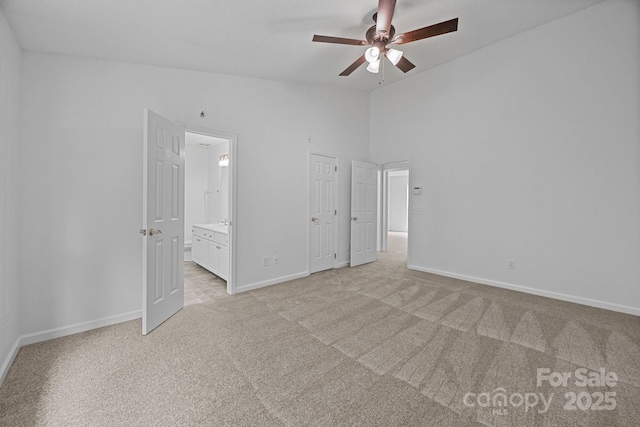 1321 Land Grant Rd, Charlotte, NC 28217 - unfurnished bedroom featuring vaulted ceiling, light colored carpet, baseboards, ensuite bath, and a ceiling fan