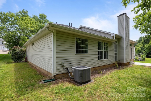 1321 Land Grant Rd, Charlotte, NC 28217 - view of side of property featuring central AC unit, a chimney, and a lawn