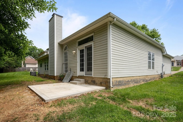 1321 Land Grant Rd, Charlotte, NC 28217 - back of property featuring a patio area, a yard, cooling unit, and a chimney