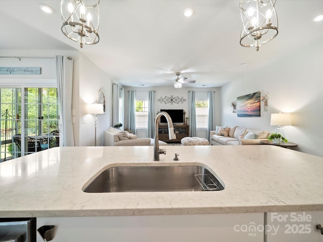 1456 Augustus Beamon Dr, Indian Trail, NC 28079 - kitchen with open floor plan, a chandelier, a sink, decorative light fixtures, and recessed lighting