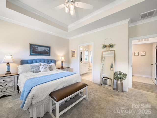 1456 Augustus Beamon Dr, Indian Trail, NC 28079 - bedroom with crown molding, light colored carpet, a tray ceiling, connected bathroom, and baseboards