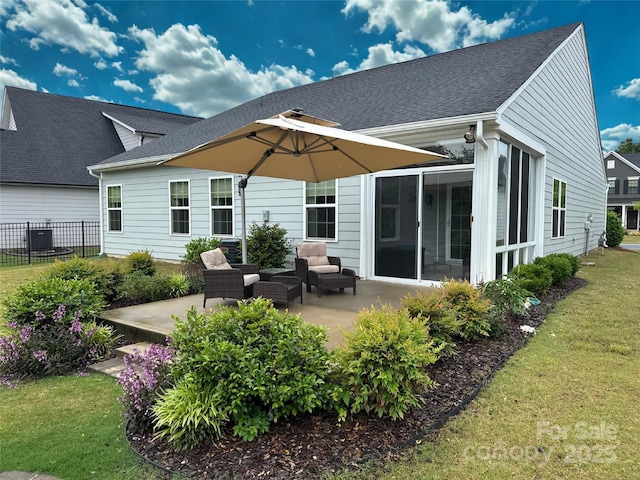 1456 Augustus Beamon Dr, Indian Trail, NC 28079 - rear view of property featuring a patio area, a sunroom, roof with shingles, and central AC
