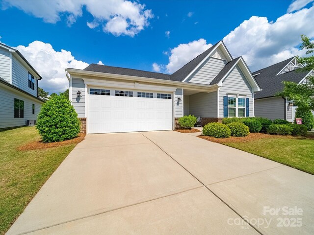 1456 Augustus Beamon Dr, Indian Trail, NC 28079 - view of front of house featuring an attached garage, driveway, a front lawn, and brick siding