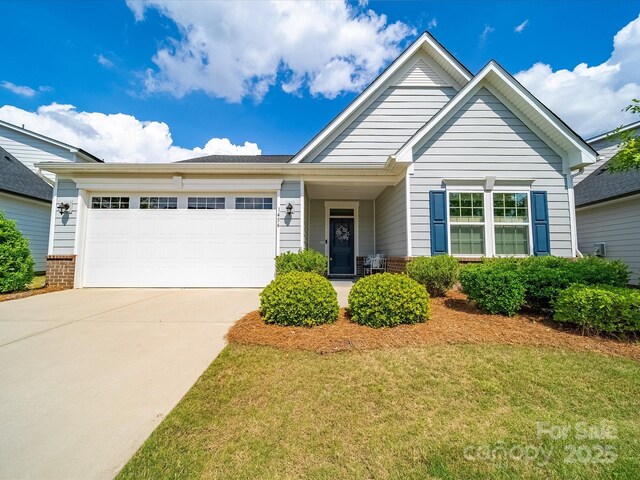 1456 Augustus Beamon Dr, Indian Trail, NC 28079 - ranch-style house with concrete driveway, an attached garage, and a front yard