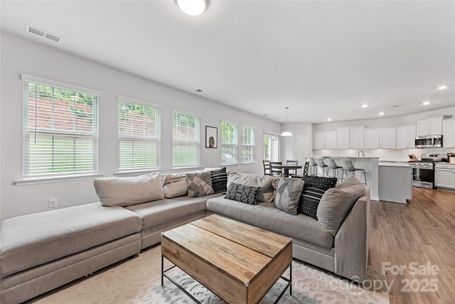 15630 Oleander Dr, Charlotte, NC 28278 - living area with light wood-type flooring and recessed lighting