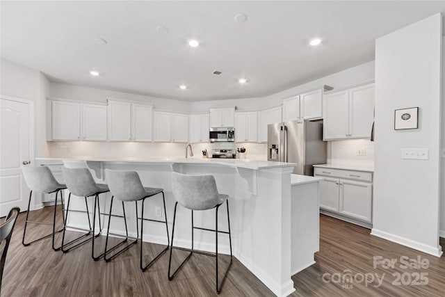 15630 Oleander Dr, Charlotte, NC 28278 - kitchen featuring stainless steel appliances, white cabinetry, dark wood-style flooring, a large island with sink, and recessed lighting