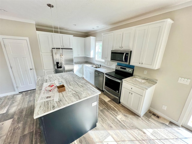 118 Brett Will Ct, Taylorsville, NC 28681 - kitchen with stainless steel appliances, white cabinets, light stone countertops, and crown molding