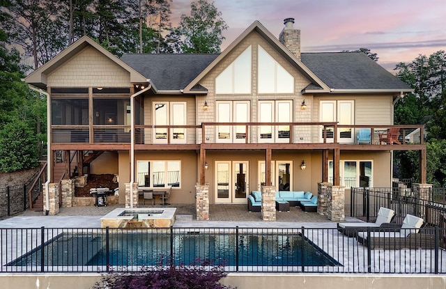 204 Ridge Dr Unit 12 12-1 12-2, Troy, NC 27371 - back of property at dusk featuring an outdoor living space, a patio area, fence, and stucco siding