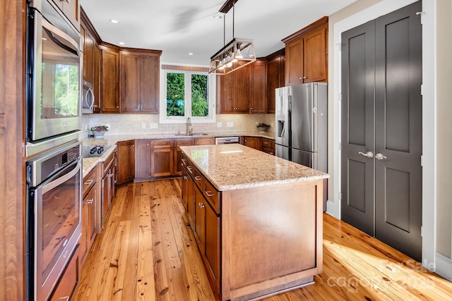 204 Ridge Dr Unit 12 12-1 12-2, Troy, NC 27371 - kitchen featuring stainless steel appliances, light wood-type flooring, a kitchen island, light stone counters, and recessed lighting