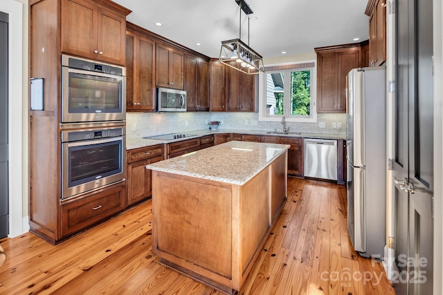 204 Ridge Dr Unit 12 12-1 12-2, Troy, NC 27371 - kitchen with appliances with stainless steel finishes, a sink, light wood-type flooring, a kitchen island, and recessed lighting