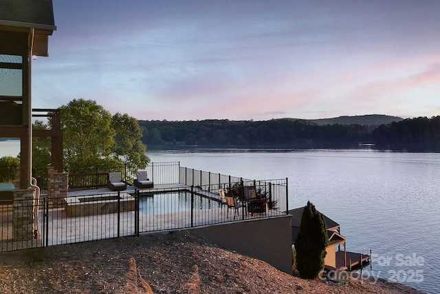 204 Ridge Dr Unit 12 12-1 12-2, Troy, NC 27371 - dock featuring a water view, fence, a view of trees, and a patio area