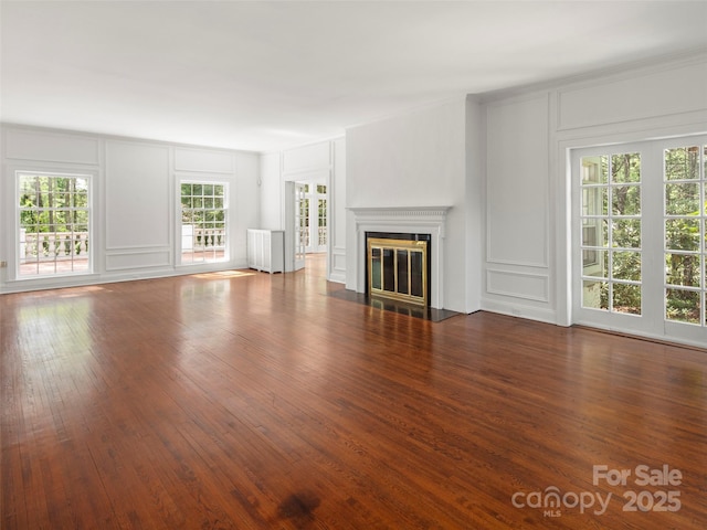 316 Vanderbilt Rd, Asheville, NC 28803 - unfurnished living room with a decorative wall, wood finished floors, and a fireplace with flush hearth