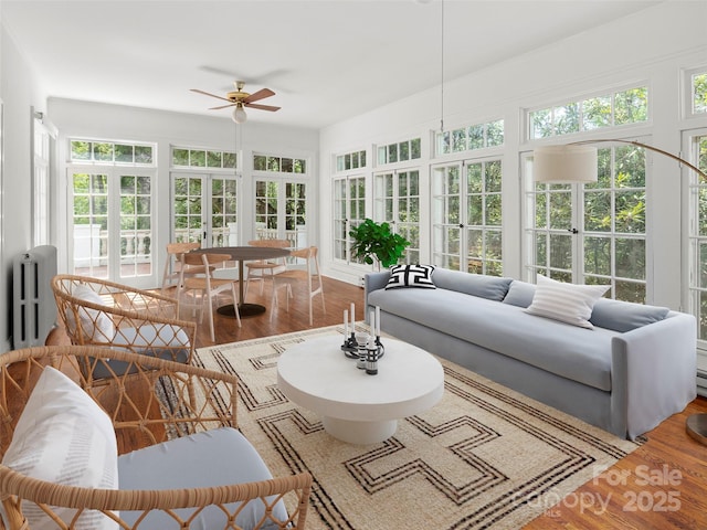 316 Vanderbilt Rd, Asheville, NC 28803 - sunroom with french doors, plenty of natural light, wood finished floors, and radiator