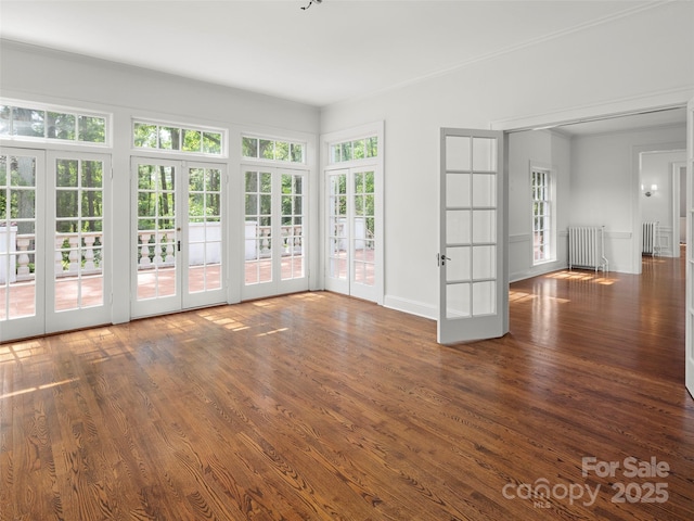 316 Vanderbilt Rd, Asheville, NC 28803 - empty room featuring french doors, wood finished floors, radiator heating unit, and baseboards