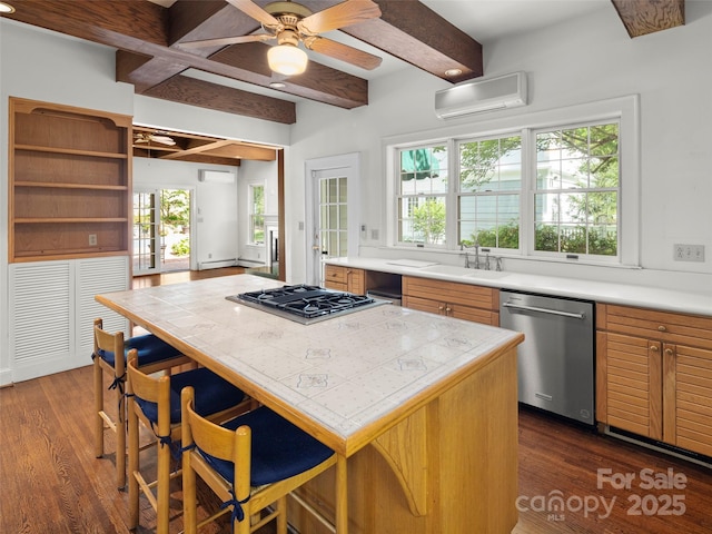 316 Vanderbilt Rd, Asheville, NC 28803 - kitchen featuring appliances with stainless steel finishes, a wall mounted AC, a sink, beam ceiling, and dark wood finished floors