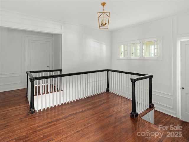 316 Vanderbilt Rd, Asheville, NC 28803 - staircase featuring a decorative wall, wood finished floors, crown molding, and a chandelier
