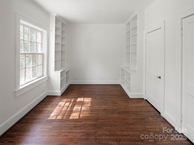 316 Vanderbilt Rd, Asheville, NC 28803 - unfurnished room with built in shelves, dark wood-style floors, ornamental molding, and baseboards
