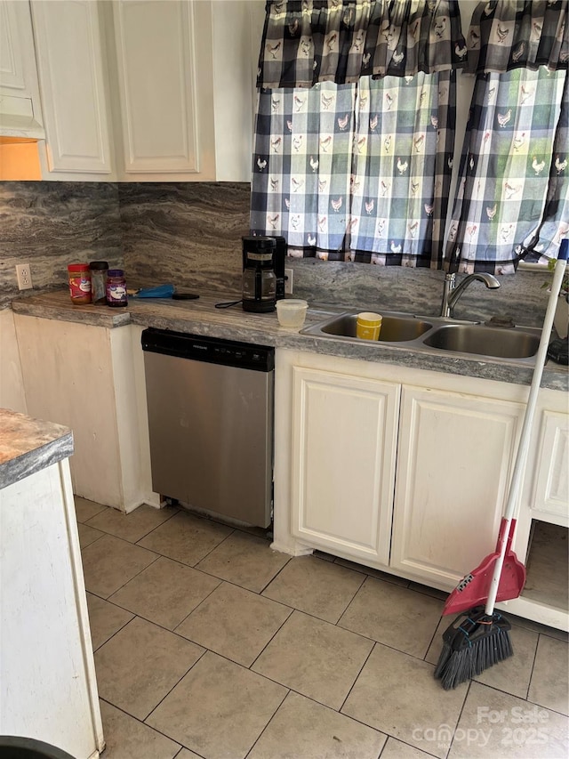 273 E Main Ave, Taylorsville, NC 28681 - kitchen with stainless steel dishwasher, a sink, light tile patterned flooring, white cabinetry, and backsplash