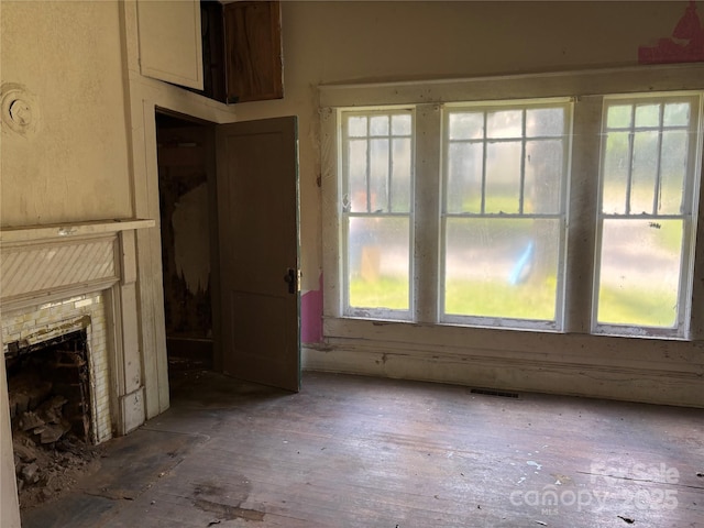 273 E Main Ave, Taylorsville, NC 28681 - unfurnished living room with healthy amount of natural light, a fireplace, and hardwood / wood-style flooring