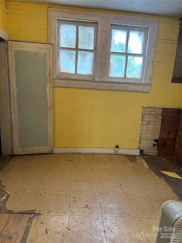 273 E Main Ave, Taylorsville, NC 28681 - empty room featuring plenty of natural light, light flooring, and wooden walls