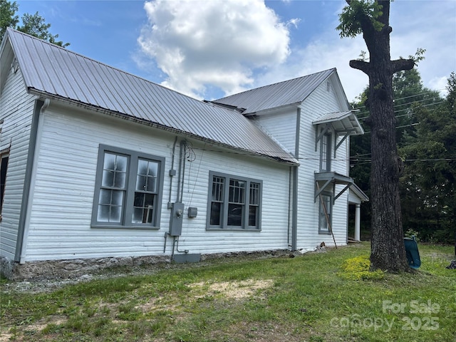 273 E Main Ave, Taylorsville, NC 28681 - view of side of home with metal roof and a lawn