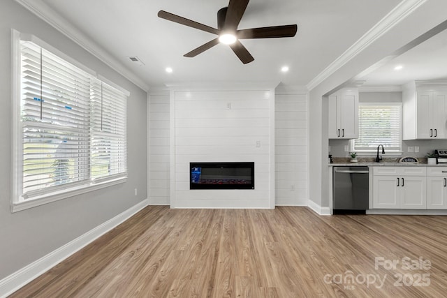 1067 Winchester Dr, Rock Hill, SC 29730 - unfurnished living room with light wood-style flooring, a sink, a ceiling fan, baseboards, and crown molding