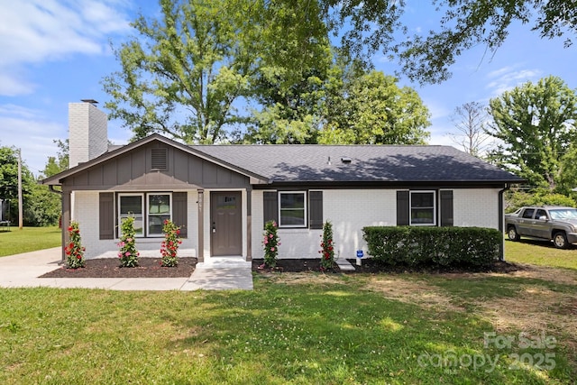 1067 Winchester Dr, Rock Hill, SC 29730 - ranch-style home with a chimney, a front lawn, brick siding, roof with shingles, and board and batten siding