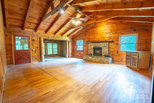 181 Settlers Ln, Waynesville, NC 28785 - unfurnished living room featuring hardwood / wood-style floors, wooden walls, wooden ceiling, a ceiling fan, and a fireplace